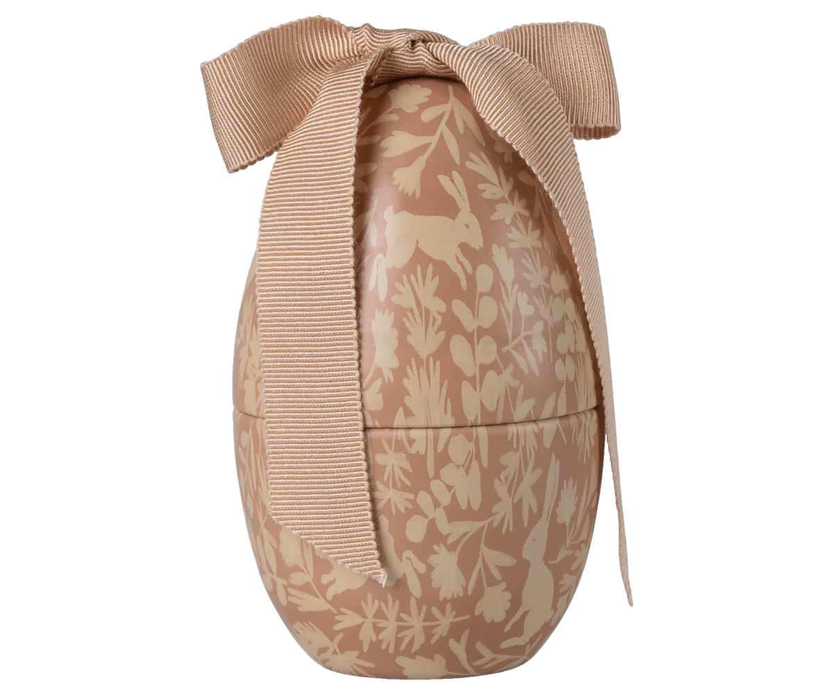 Decorative Easter egg with floral patterns and a bow on a white background