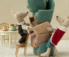 maileg king mouse with Stack of plush chairs with animal figures on a neutral background