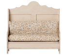 A rustic wooden bench with a distressed cream finish and a matching floral patterned cushion set, shown against a plain white background.