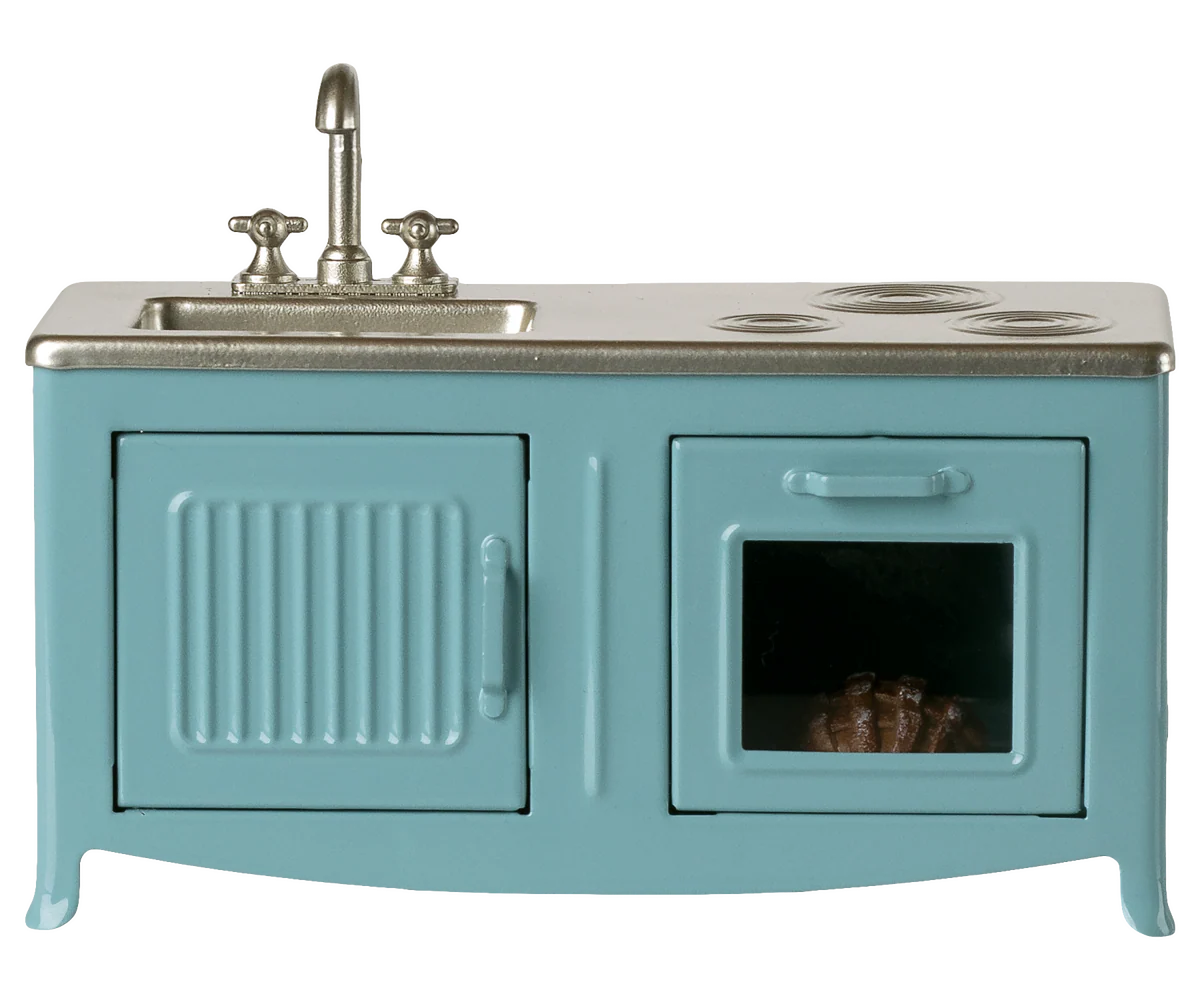 Teal vintage-style stove with sink on a white background