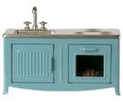 Teal vintage-style stove with sink on a white background
