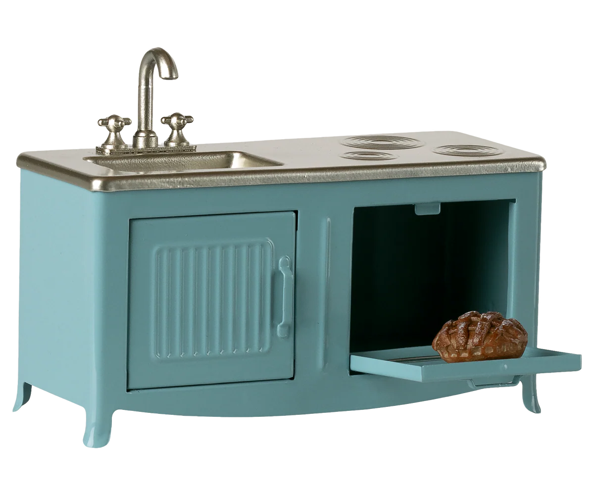 Teal toy kitchen set with sink and stove on a white background