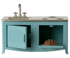 Teal dollhouse kitchen set with sink and stove on a white background