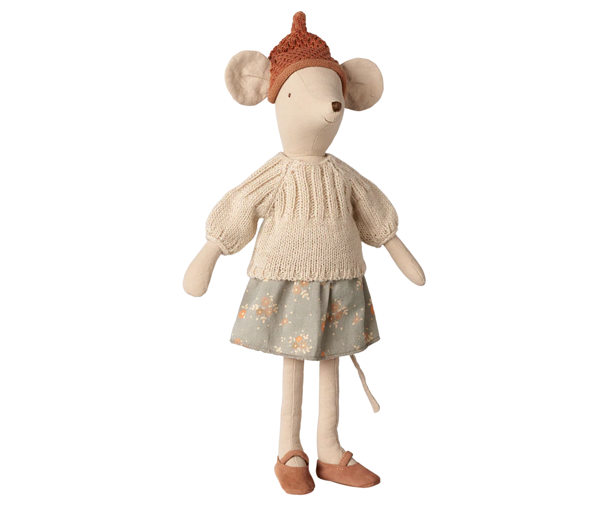 A plush mouse doll wearing a cream knit sweater, a dusty blue skirt with a small floral pattern, and a brown knit hat, set against a plain white background.