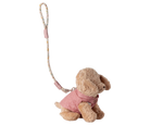 Stuffed animal toy with a pink outfit and strap on a white background