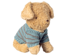 Stuffed dog wearing a blue striped sweater on a white background