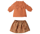 A two-piece children's outfit set featuring a rust-orange knit sweater with textured details and a matching brown floral-patterned skirt, displayed on a solid white background.