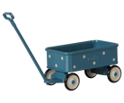 A teal blue toy wagon with white polka dots, cream-colored wheels with black rims, and a matching blue handle, shown on a plain white background.