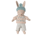 Toy rabbit wearing a knitted sweater and hat on a white background