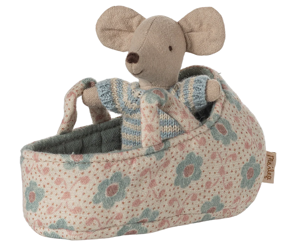 Stuffed mouse toy in a floral-patterned crib on a white background