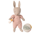 Stuffed rabbit toy in a pink outfit with a ball and bottle on a white background