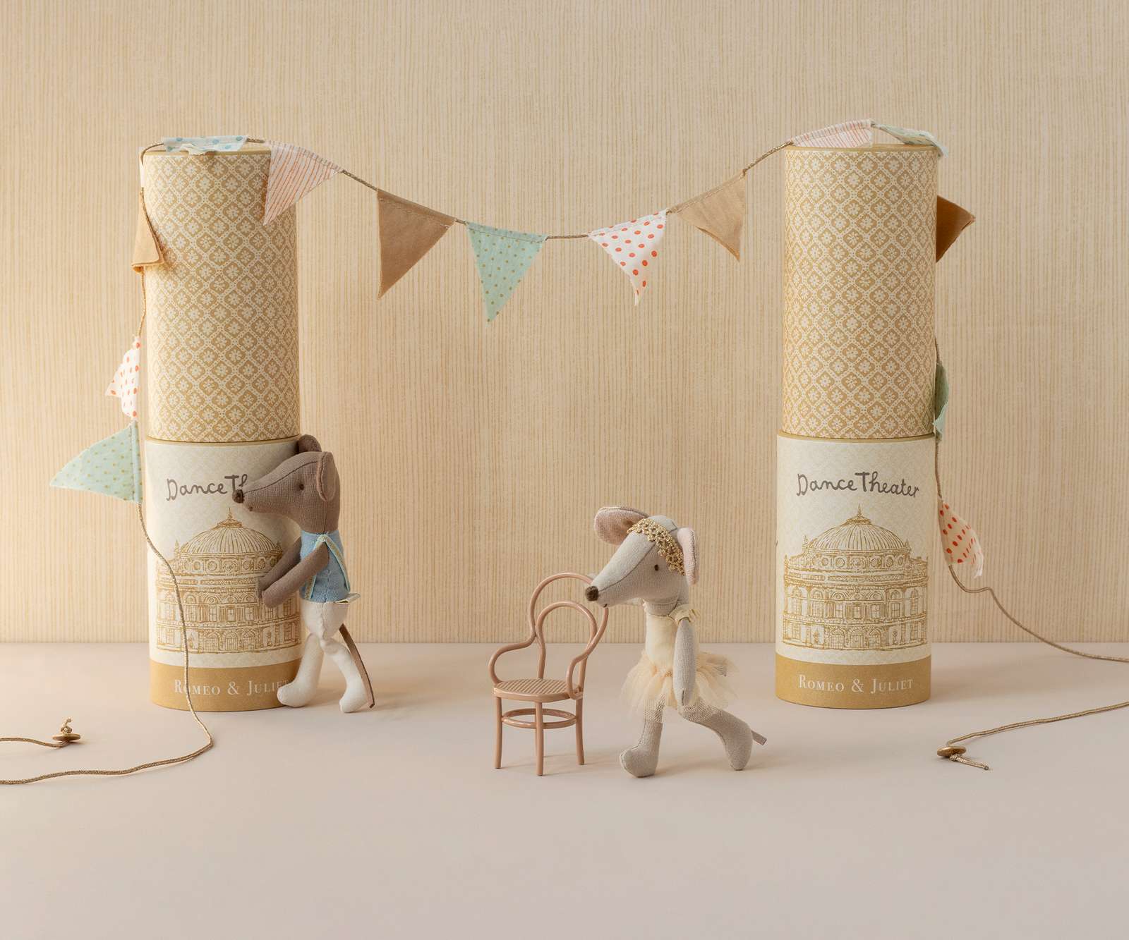 Two Maileg ballerina mice in decorative boxes with a banner on a neutral background