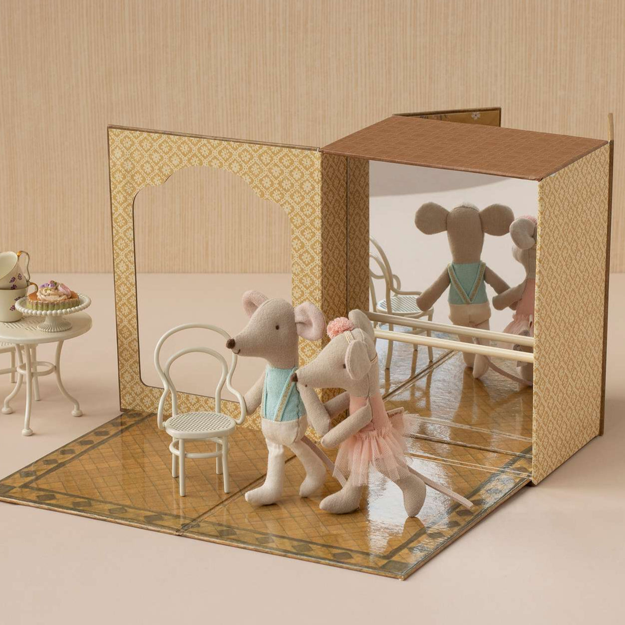 MAileg mice toys in a dance studio  setting with furniture and a mirror.