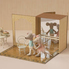 MAileg mice toys in a dance studio  setting with furniture and a mirror.