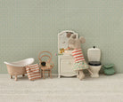 Miniature bathroom set with a mouse character washing hands, featuring a bathtub, sink, and toilet.