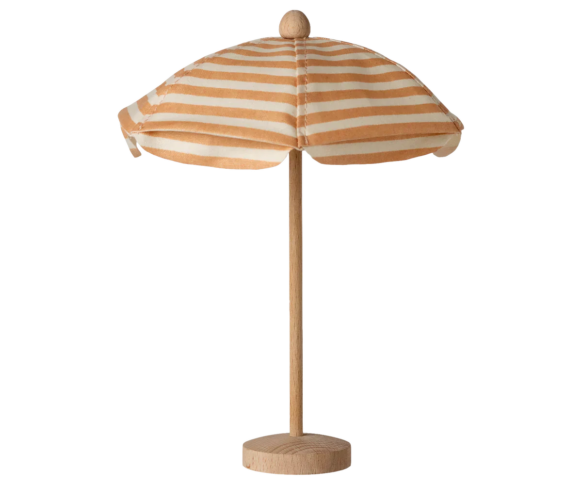 Striped beach umbrella with wooden base on a white background
