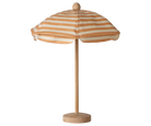 Striped beach umbrella with wooden base on a white background