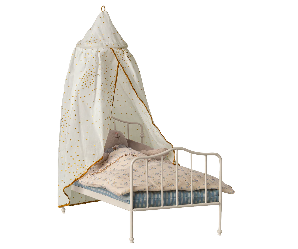 maileg toys bed with canopy and bedding on a white background