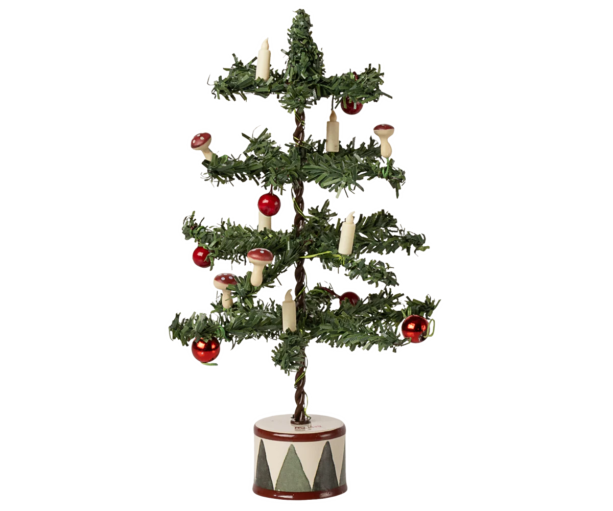 Decorative miniature Christmas tree for a dolls house with red ornaments and candles on a white background
