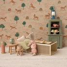 Miniature Maileg dollhouse scene with a girl mouse, furniture, and decorative elements against a patterned wallpaper.
