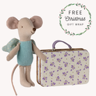 Stuffed mouse toy with a suitcase featuring a floral pattern, with text about free Christmas gift wrap.
