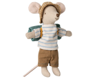 Toy mouse dressed in a striped shirt, shorts, and hat with a backpack on a white background