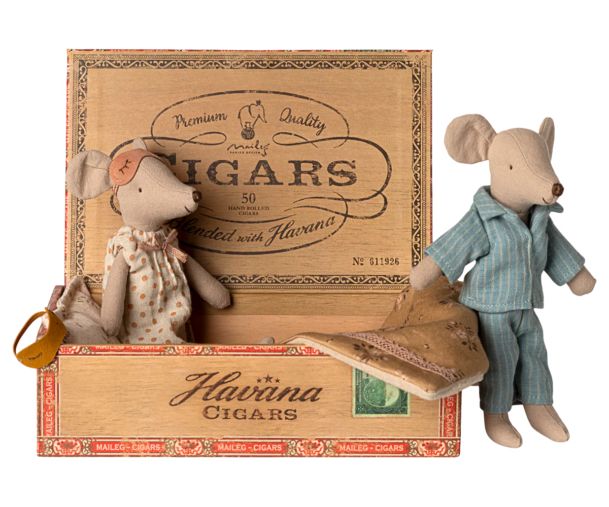 Two toy Maileg mice in a wooden Havaina Cigars box on a white background