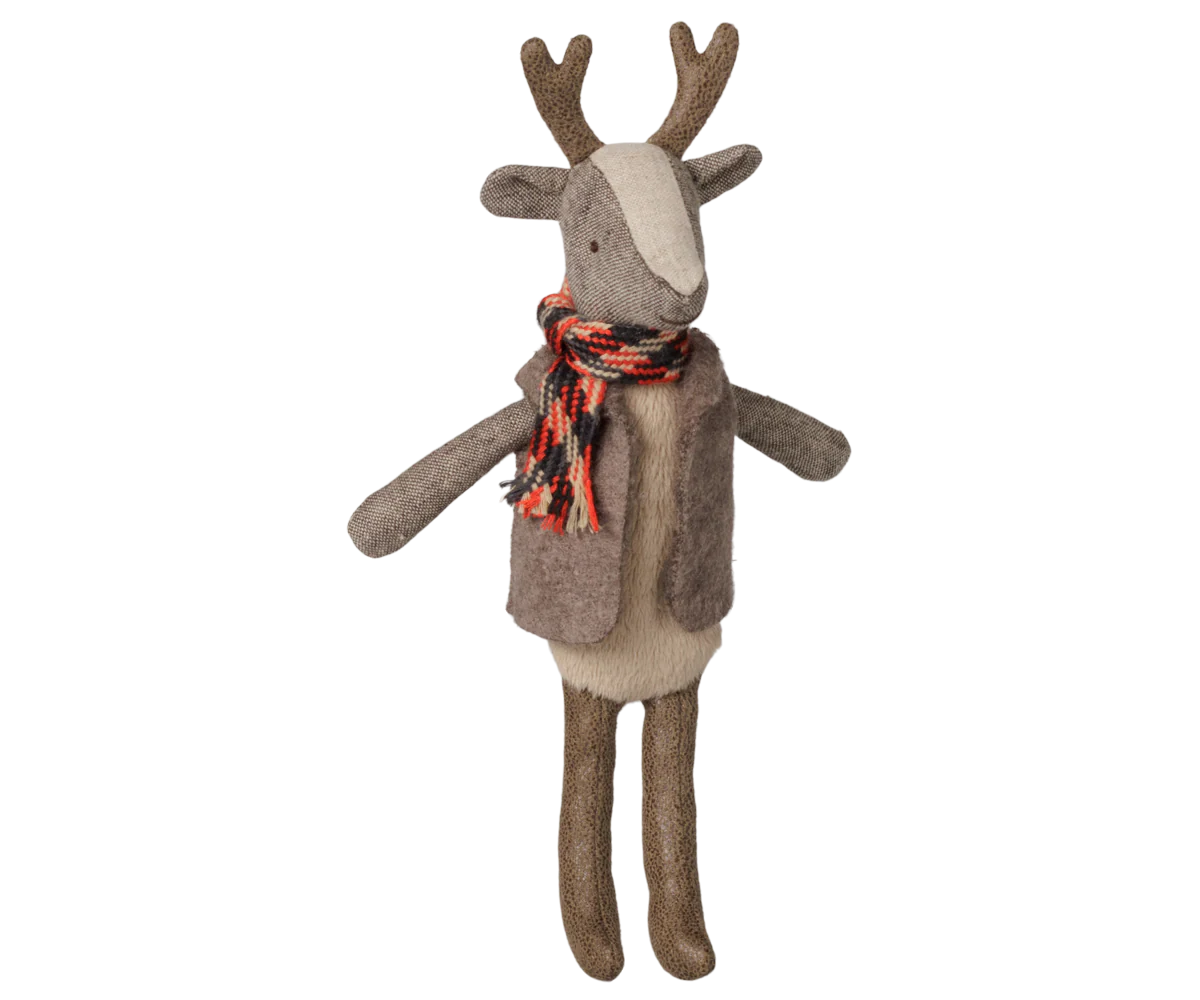 A plush reindeer toy with brown antlers and legs, a beige face and belly, and a brown vest, wearing a red, orange, and black patterned scarf, isolated on a white background.