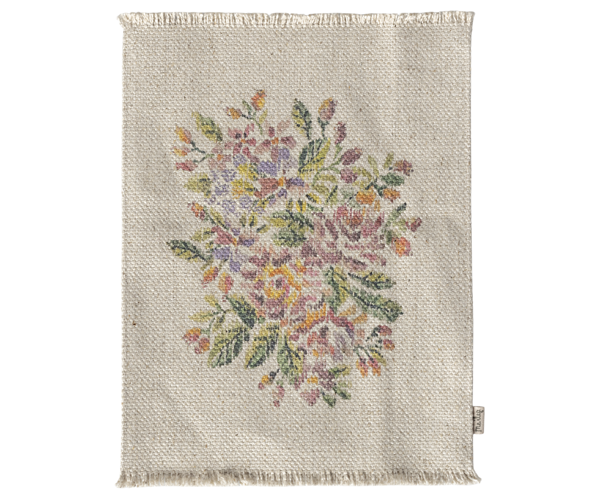 A small floral-patterned rug for a dolls house, made of cotton linen, with a colorful depiction of flowers.