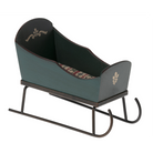 Vintage-style baby crib with floral patterned interior on a white background