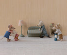 Miniature scene with toy mice in a living room setting.