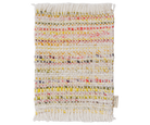 A rectangular woven textile rug or mat with fringed edges, featuring horizontal stripes of multicolored yarns on an off-white base. A small fabric tag is visible at the lower right corner.