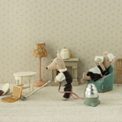 MAileg mice watier and maid in a living room with a vacuum cleaner