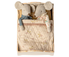 Two plush mouse toys in a wooden box with a quilted blanket