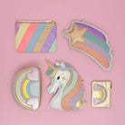 Set of colorful childs bags with unicorn and rainbow designs on a pink background