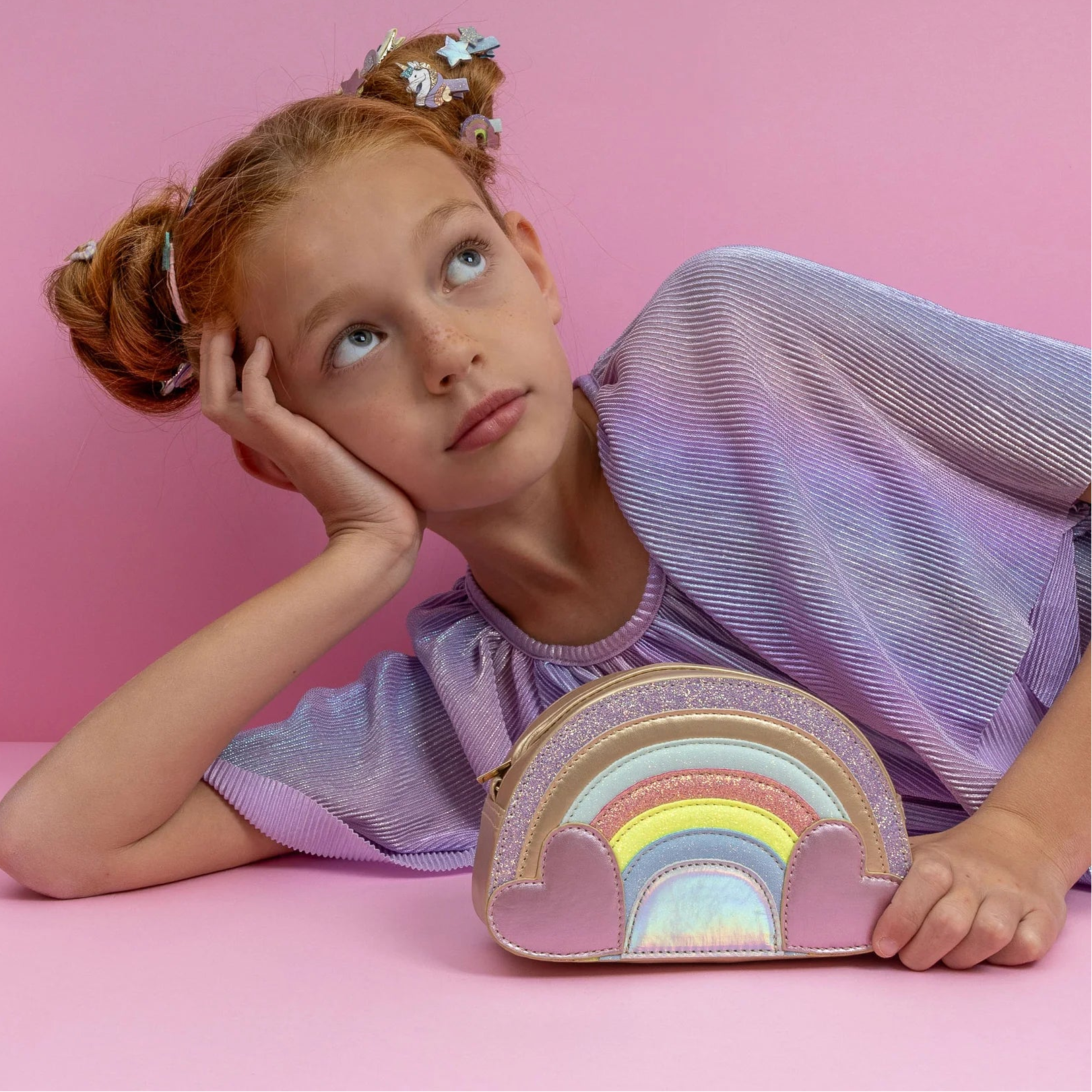 girl with Mimi & Lula Rainbow Bag on a pink background