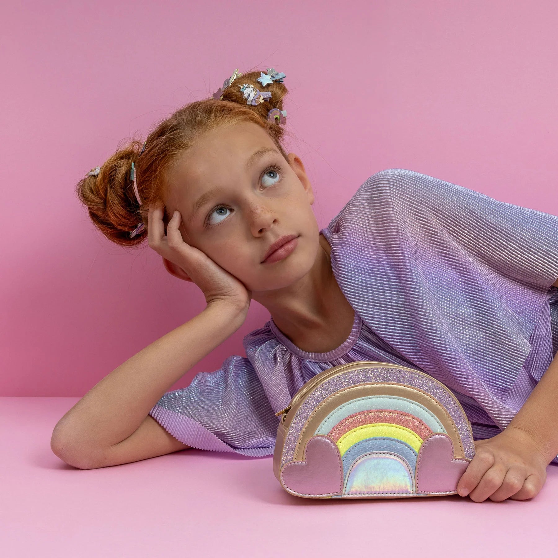 girl with Mimi & Lula Rainbow Bag on a pink background