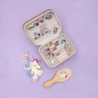 Open jewelry case with hair accessories on a purple background