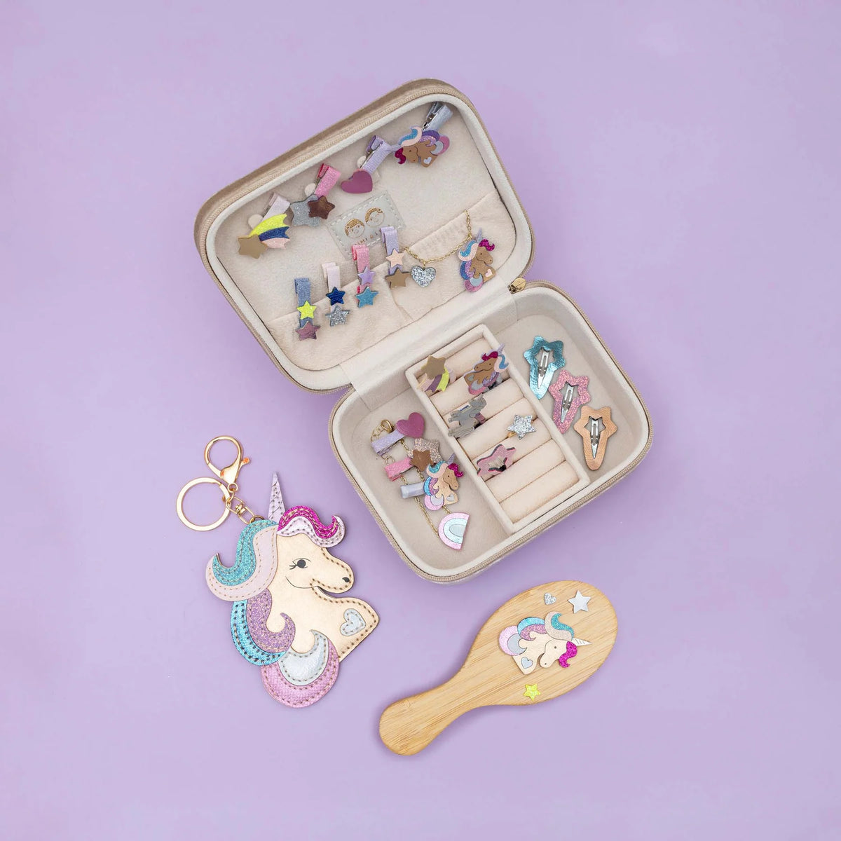 Open jewelry case with hair accessories on a purple background