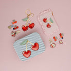 childs purse made of pink gingham check fabric decorated with a heart cherry motif 