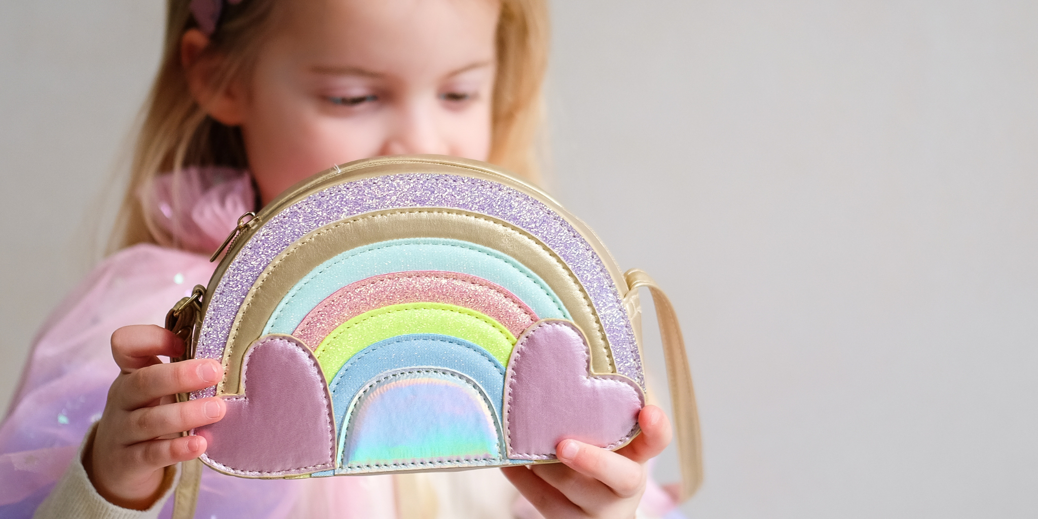 girl holding rainbow shaped bag from the Mimi and Lula spring summer 26 collection