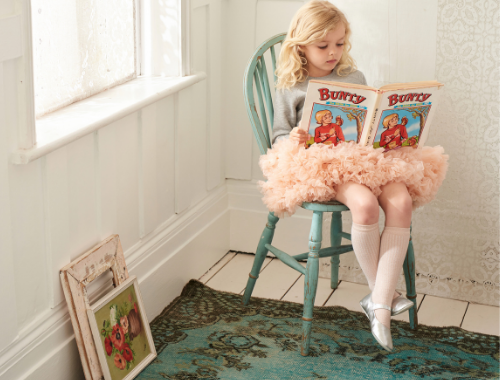 Girl wearing Bob and Blossom tutu reading Bunty comic