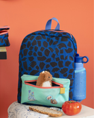 Blue backpack with black spots, a small bag with a toy, and a blue water bottle on an orange background.