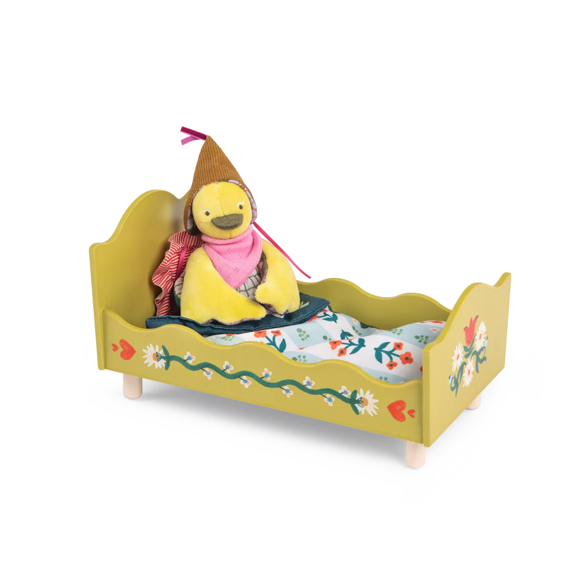 Yellow toy duck in a bed with a floral pattern on a white background