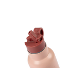 Close-up of a pink water bottle with a red straw lid on a white background