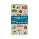 Crayon set packaging with illustrations of houses and camping equipment on a white background