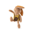 A plush toy rabbit character in a yellow outfit with a brown hat and small brown bag, posed against a plain white background.