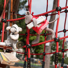 Two plush toy mice on a playground structure with books and a compass.