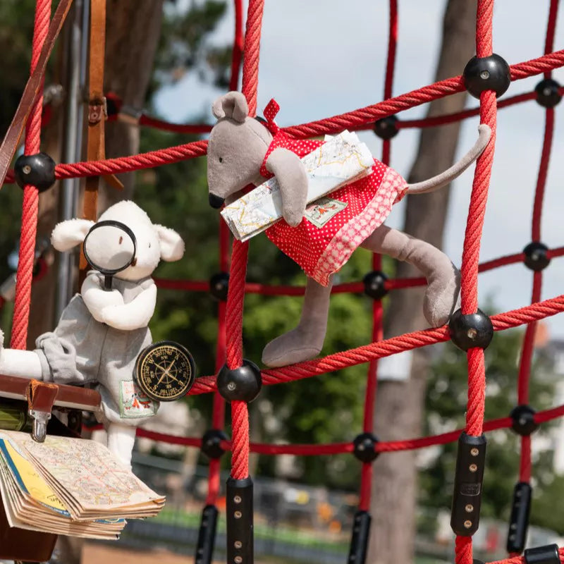 Two plush toy mice on a playground structure with books and a compass.