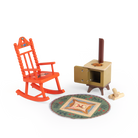miniature Wooden rocking chair, stove, rug, and logs on a white background